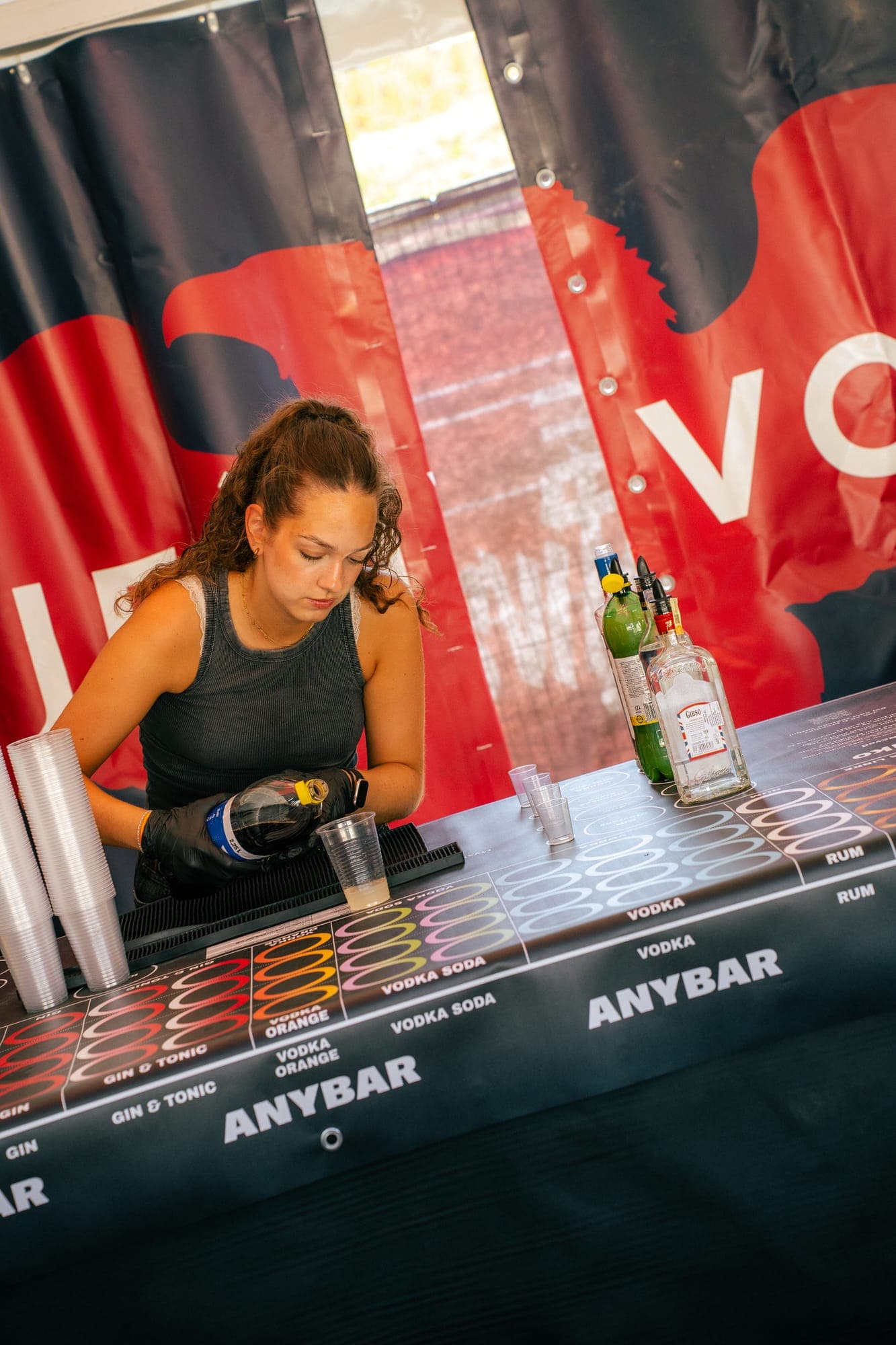 Crewmate bartender preparing drinks at an AnyBar festival bar