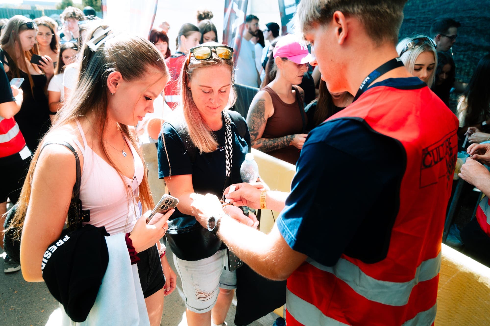 Crewmate staff checking visitors in at a festival entrance