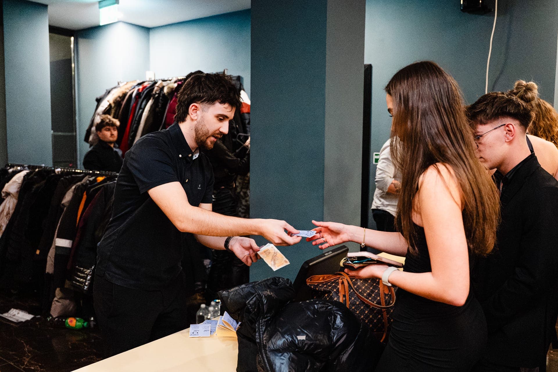 Crewmate cloakroom staff taking coats from guests